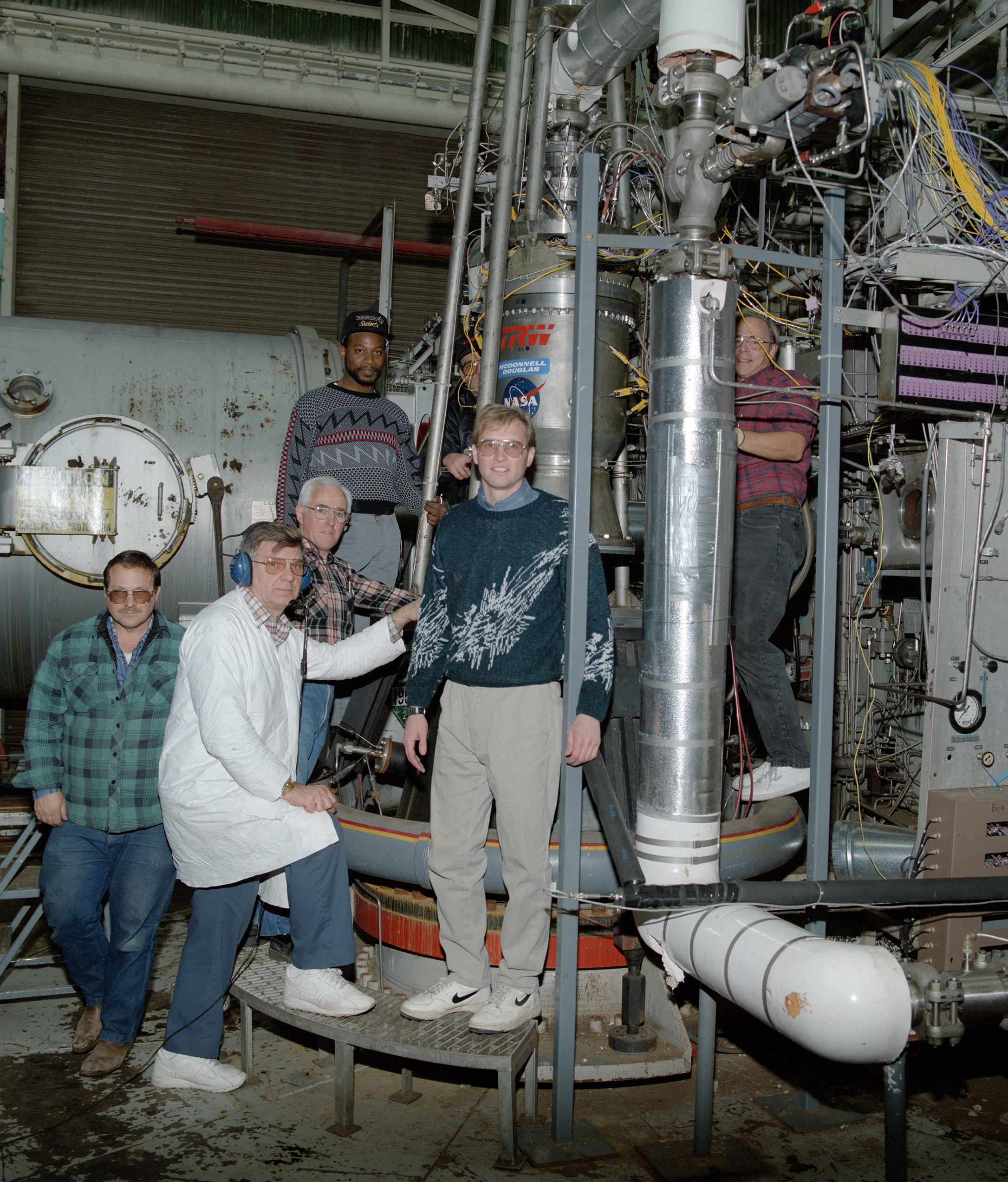 RETF staff with engine in test stand