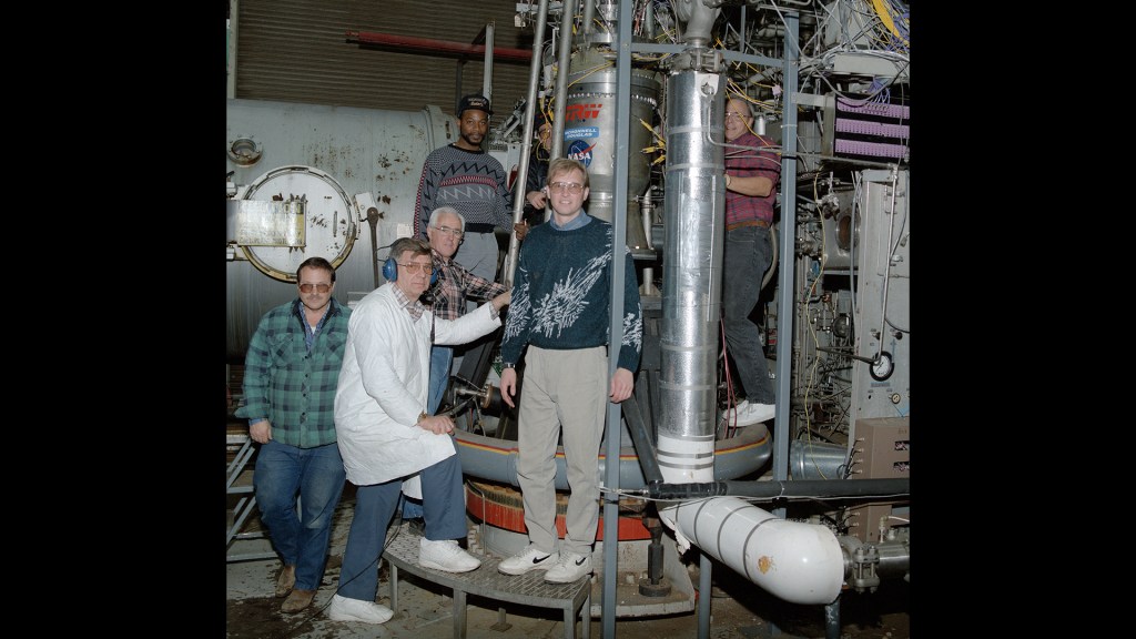 RETF staff with engine in test stand