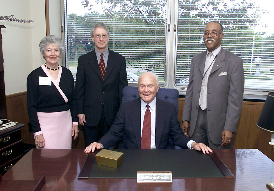 Group at desk in office.