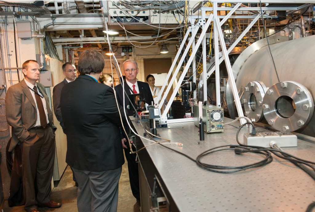 Group of people looking at test equipment.