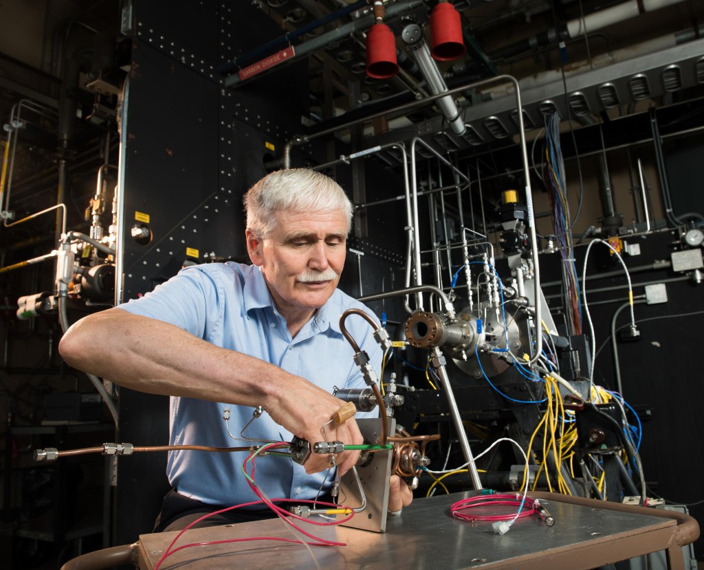 Man working on test equipment.