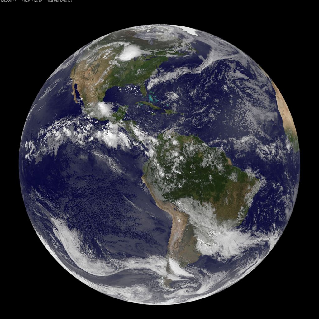 This full-disk image from NOAA’s GOES-13 satellite shows North and South America on the summer solstice on June 21, 2012. The land is green and brown, while Earth's waters appear deep blue. Clouds swirl all over Earth.