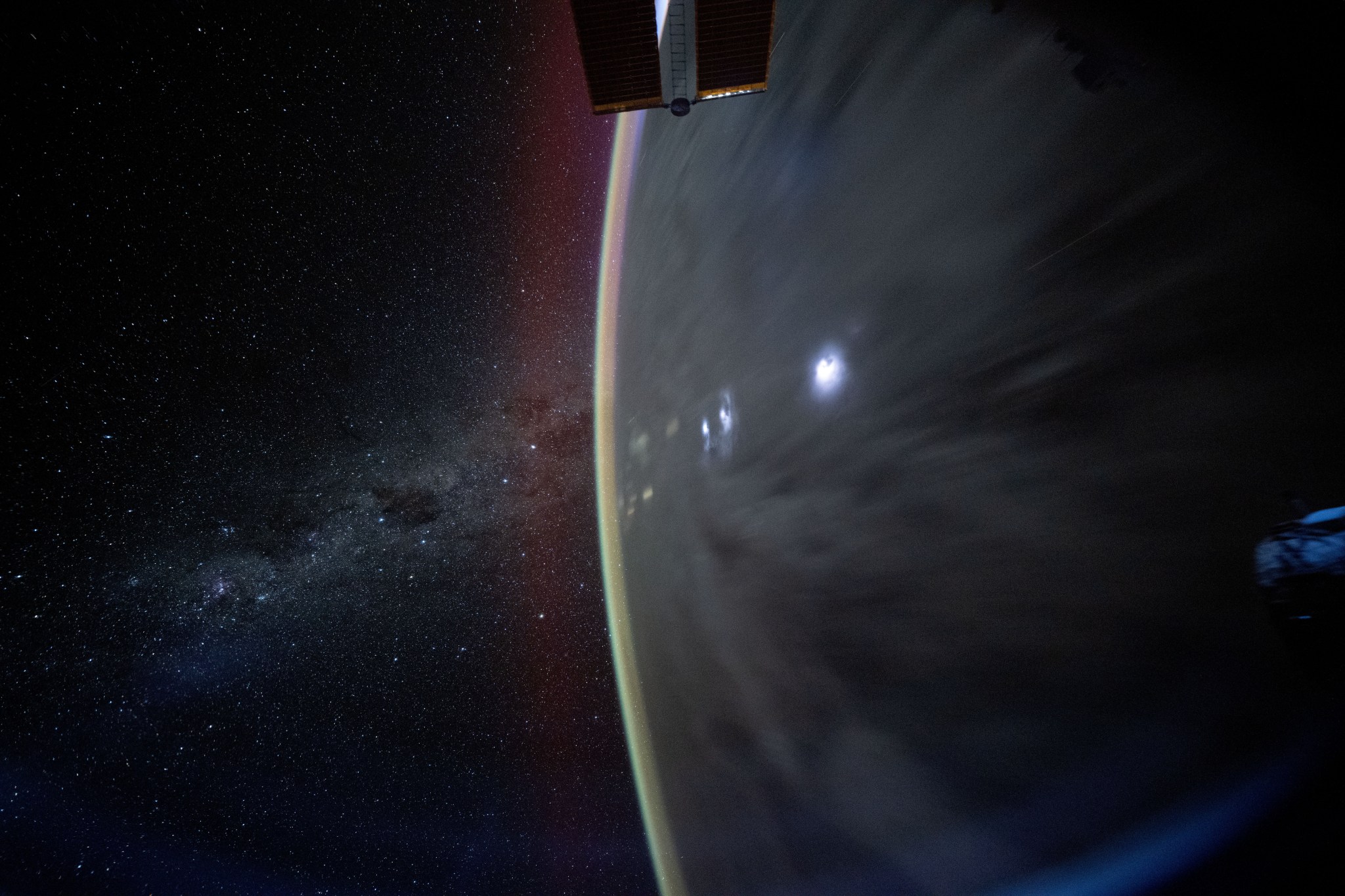 The Milky Way appears beyond Earth's horizon in this celestial photograph captured by NASA astronaut Don Pettit using a camera with low light and long duration settings as the International Space Station orbited 259 miles above the Coral Sea off the coast of Queensland, Australia.