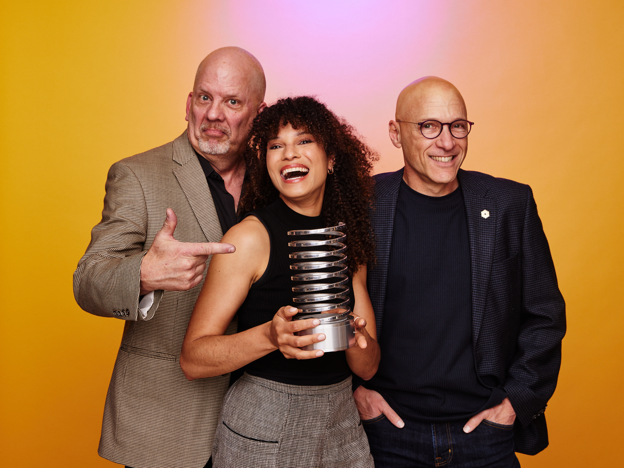 Sophia and two coworkers hold a shared award