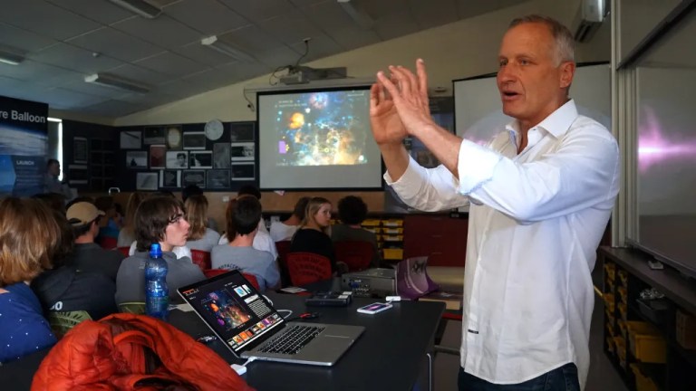 A person teaching students about scientific balloons.