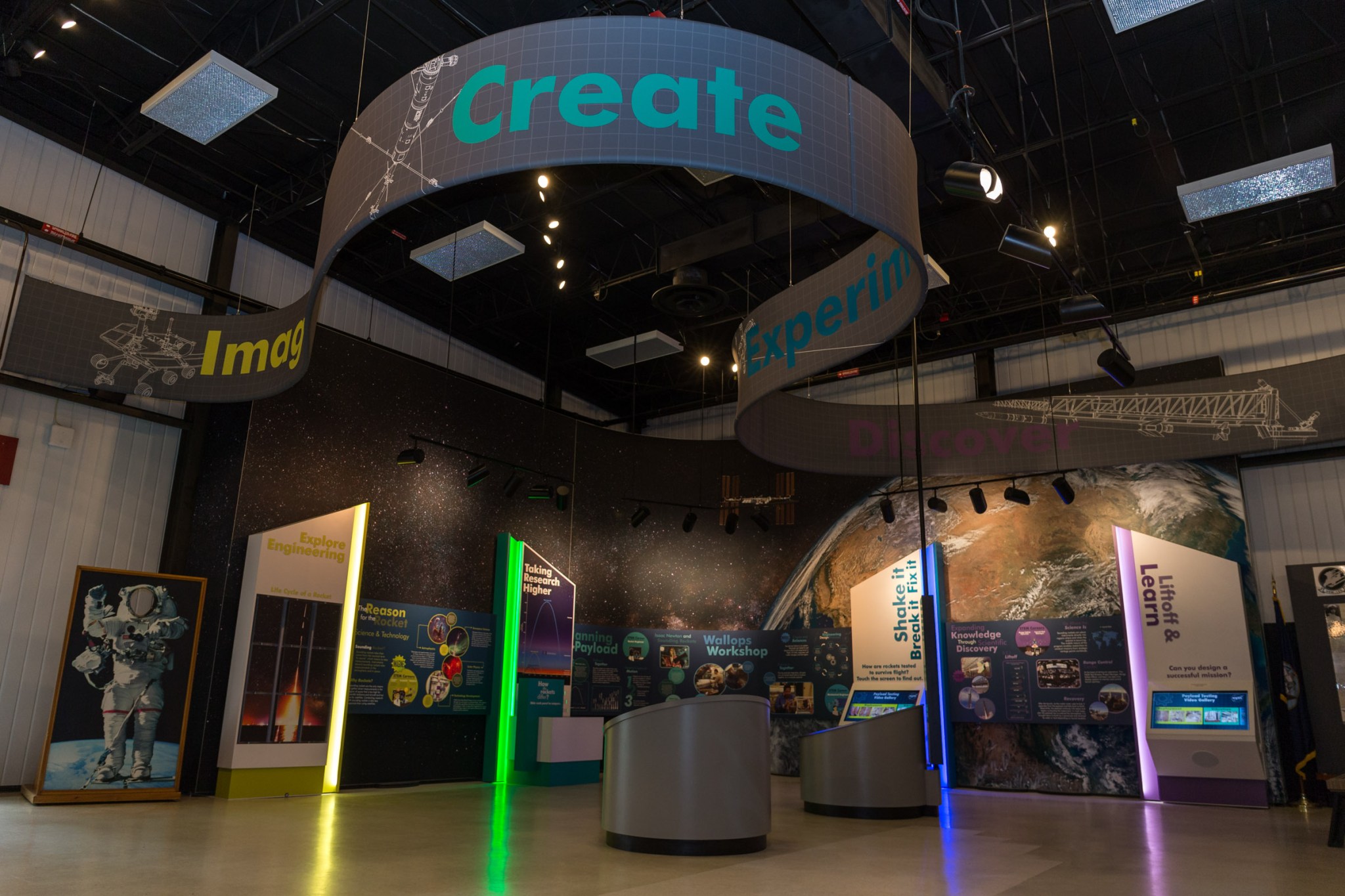 The sounding rocket display at NASA Wallops Flight Facility Visitor Center. A sign that says "Create" hangs from the ceiling with exhibits below