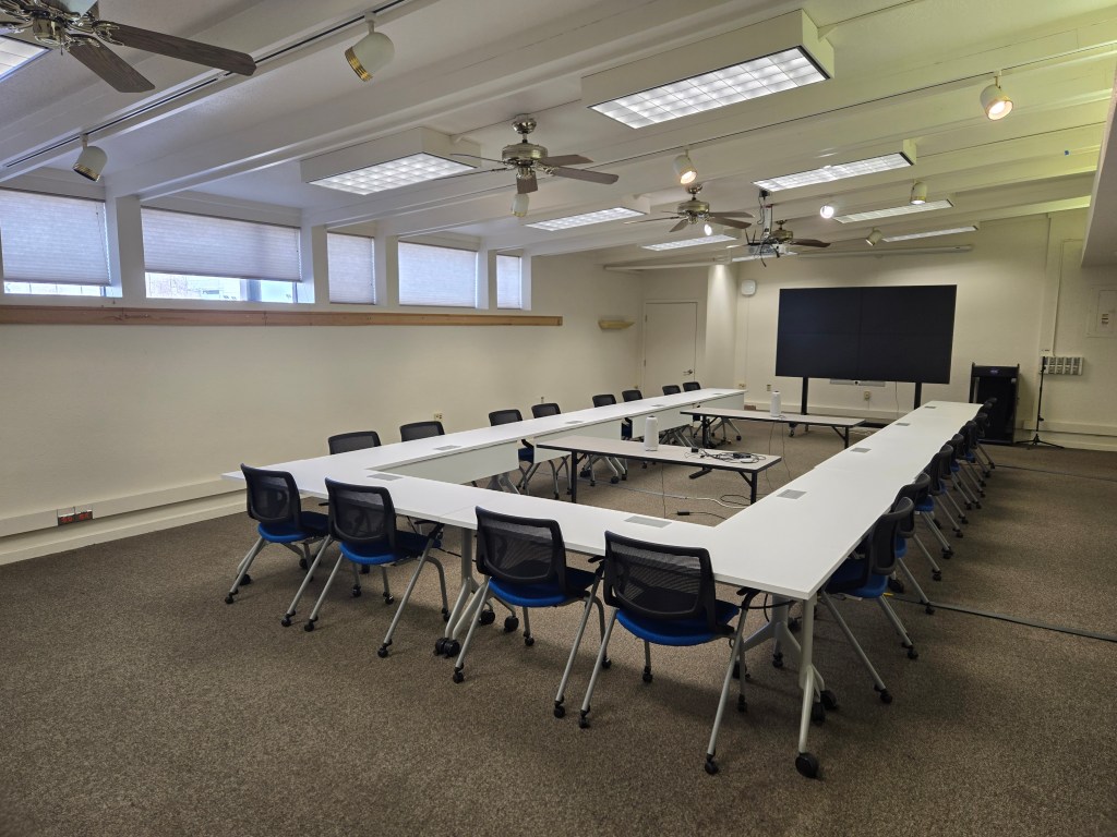 The North Wing meeting room shown in it's default configuration with a U-shaped table layout and seating for 20 attendees.