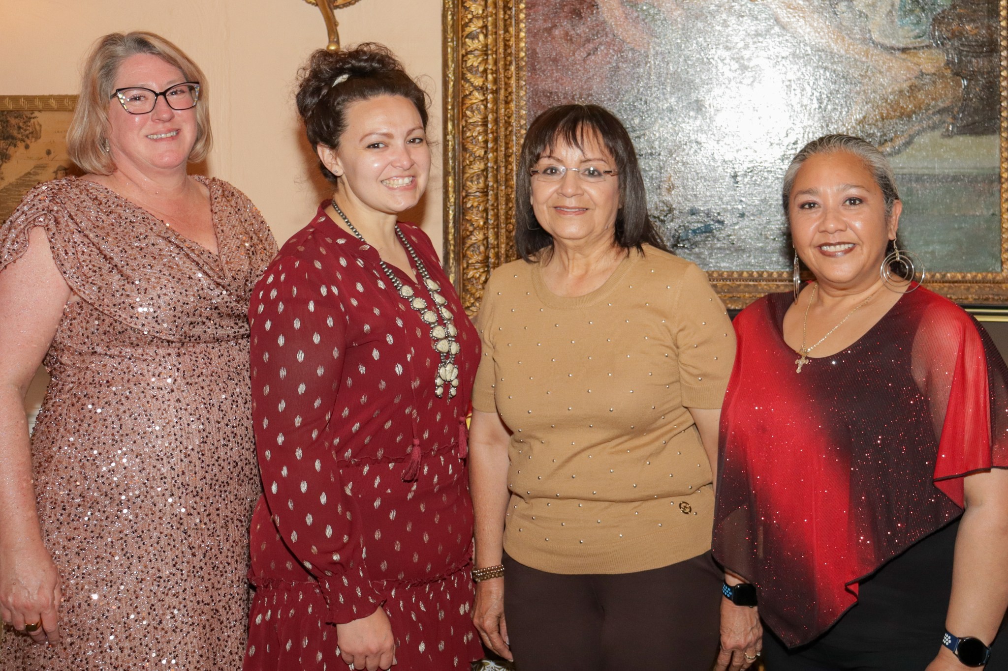 Four women pose out