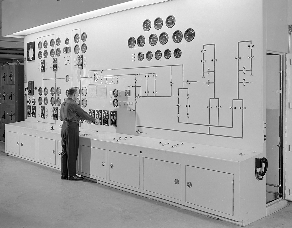 Man at large control panel.