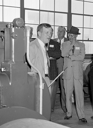 Group of men looking at equipment.