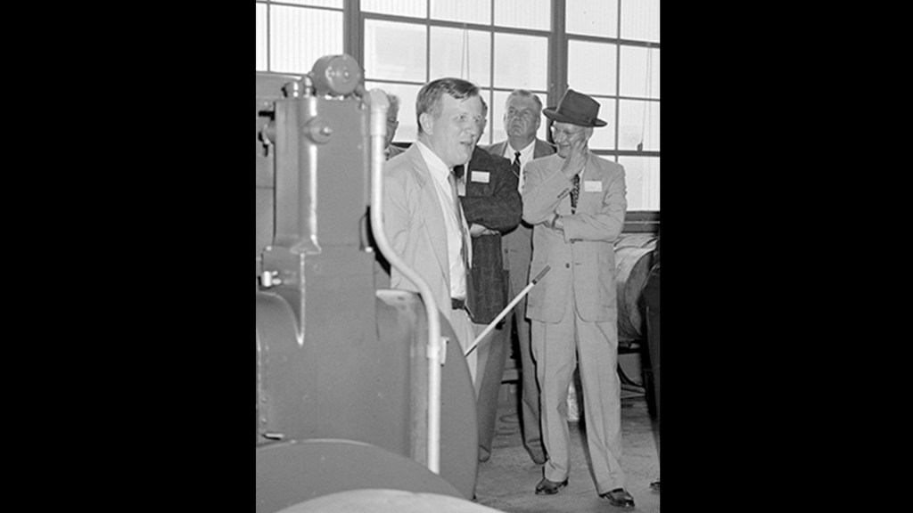 Group of men looking at equipment.