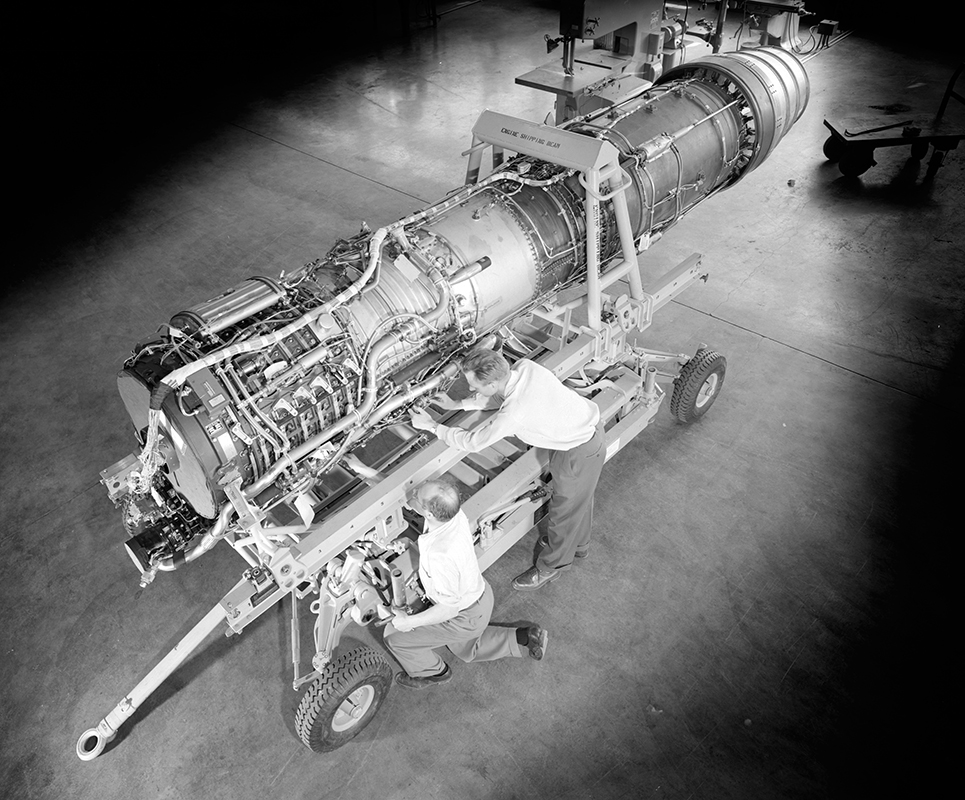 View from above of mechanic working on engine.