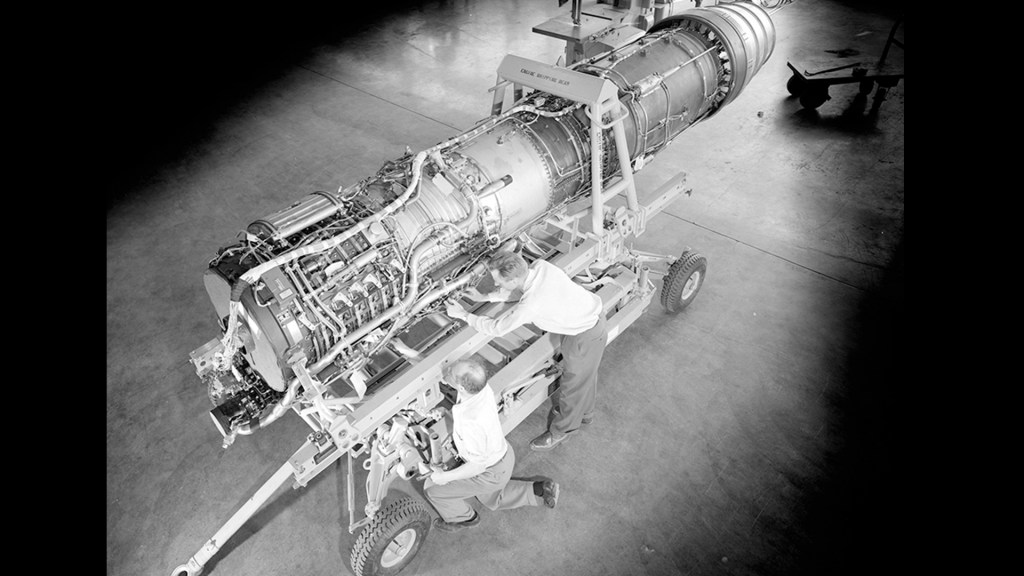View from above of mechanic working on engine.
