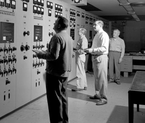 Men looking at control panels.