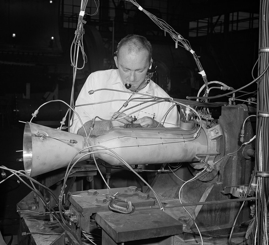 A mechanic installs a small rocket