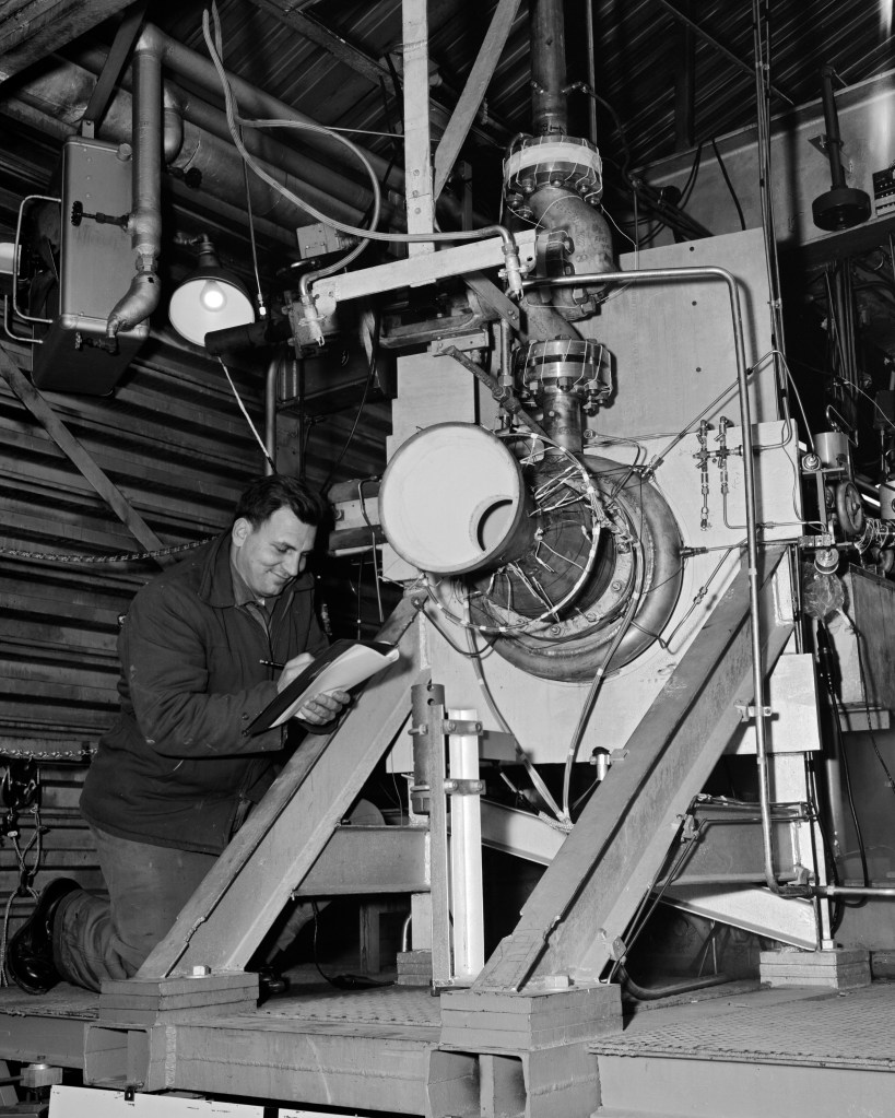 A mechanic checks on an engine setup