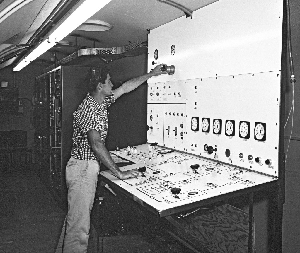 Operator at panel in control Room