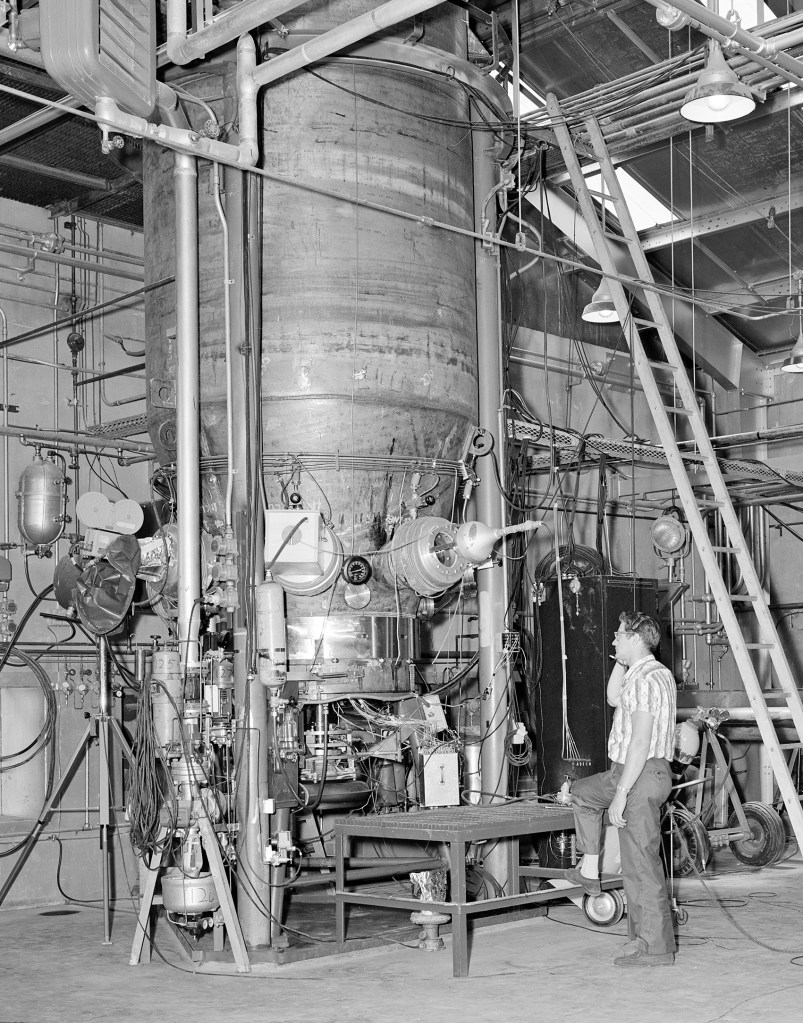 A technician examines The Boiling Fluids Rig inside C Site