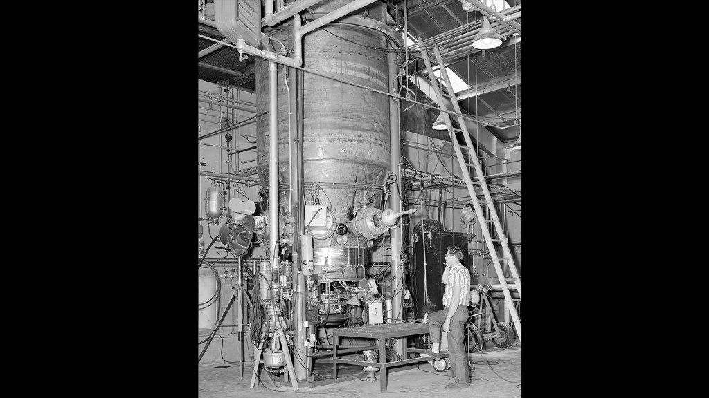 A technician examines The Boiling Fluids Rig inside C Site