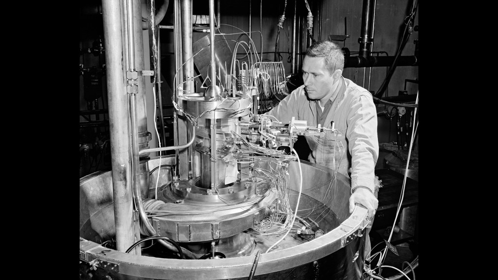 Mechanic examines pump setup for the Boiling Fluids Rig