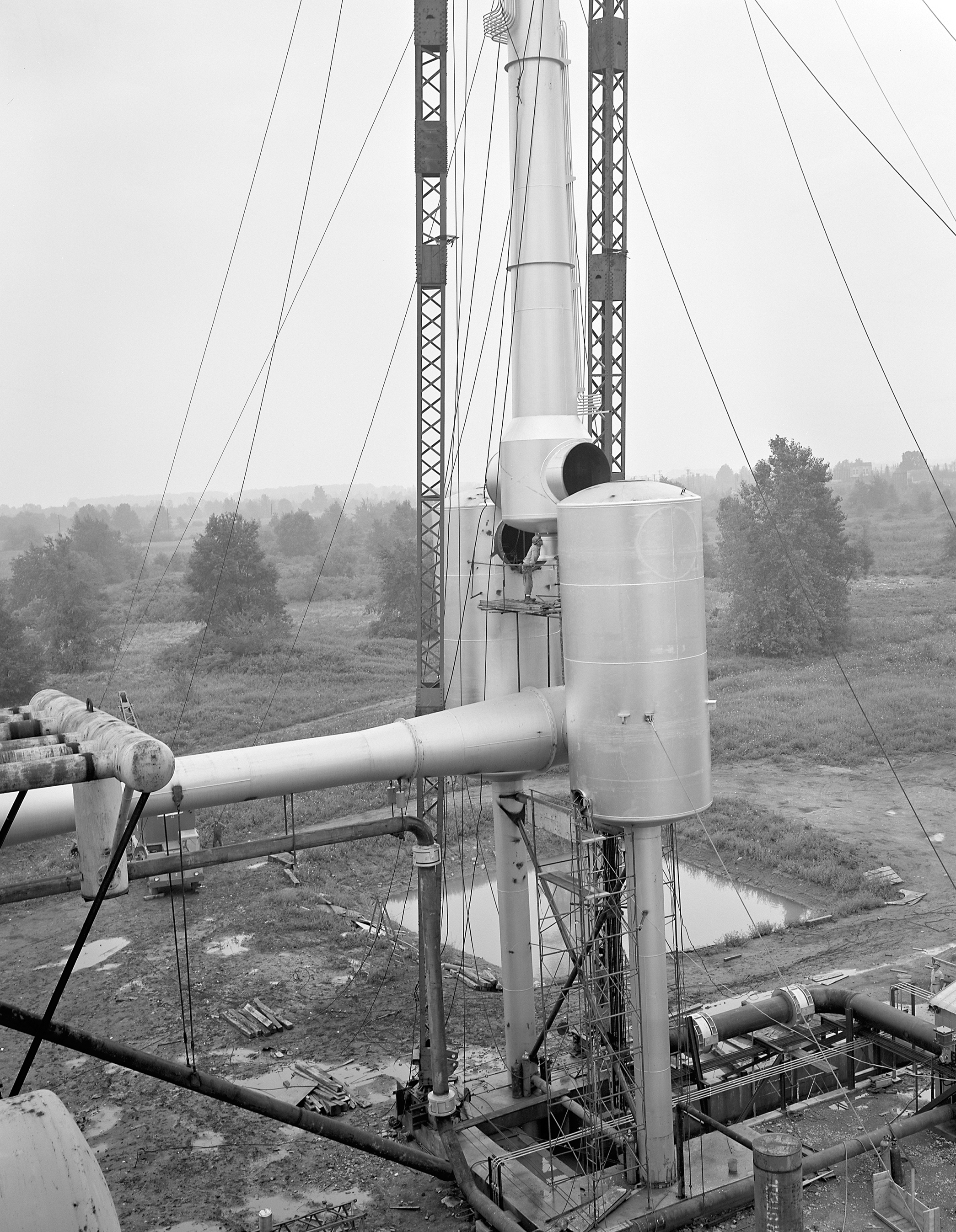 Crane lifting section of ejector into place.