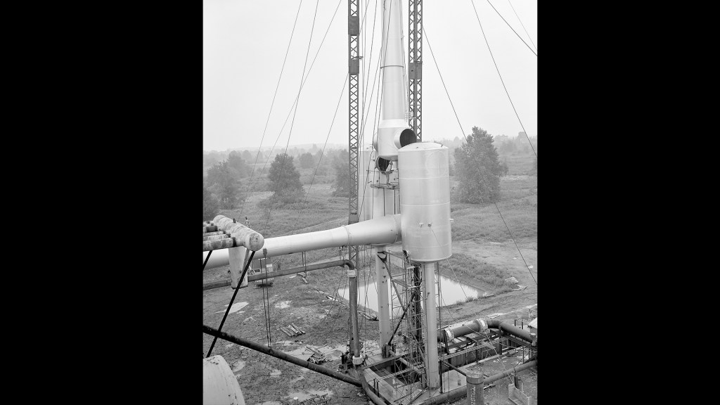 Crane lifting section of ejector into place.