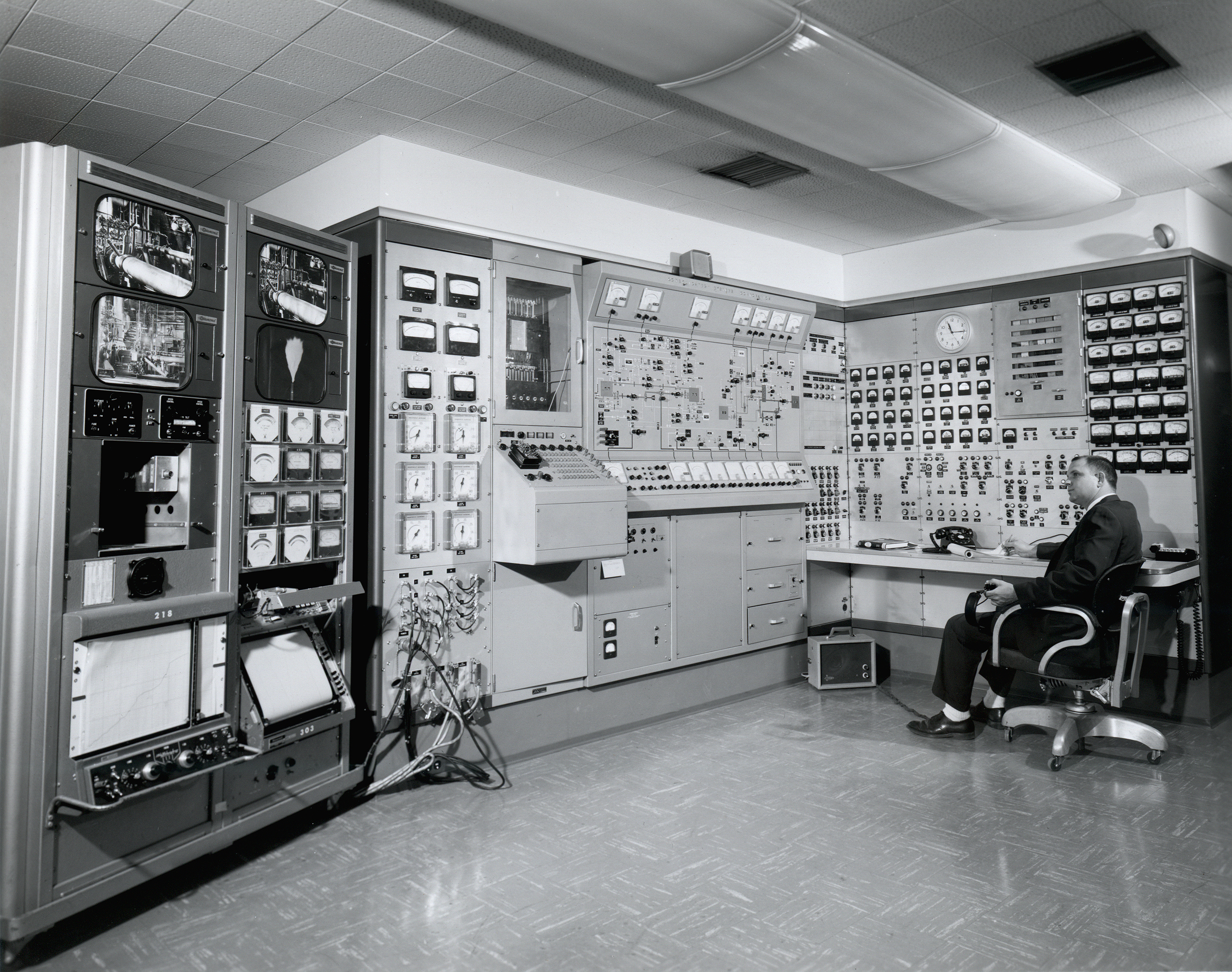 Men in control room.