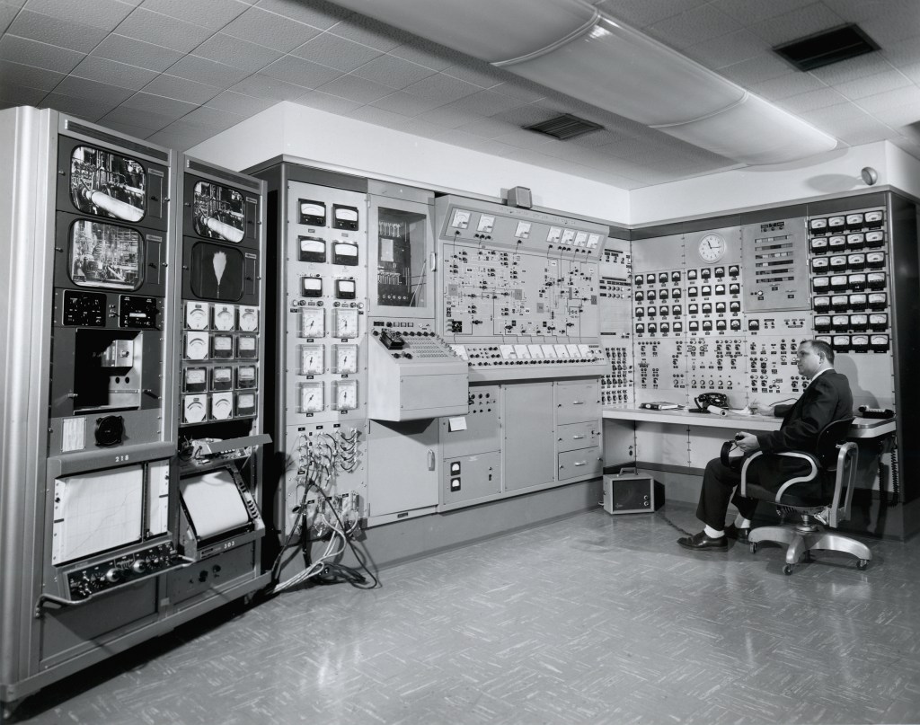 Men in control room.