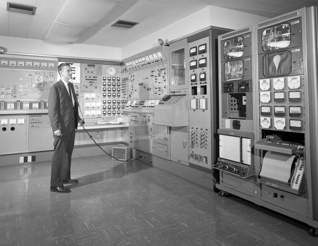 Man standing in control room.