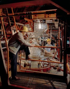 Two engineers examine Kiwi engine in B-1 stand