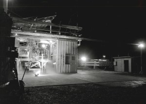 Rocket engine firing horizontally out of J-1 at night