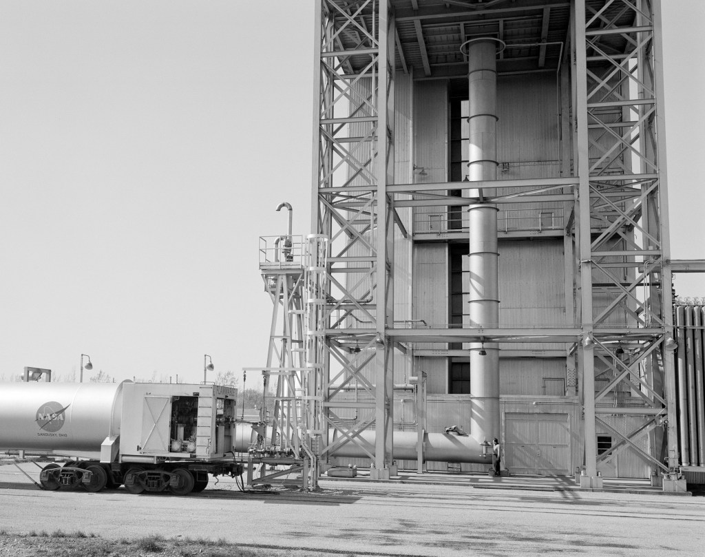 Ground level of the B-3 stand showing the facility's exhaust line. A railroad tank car is at the left