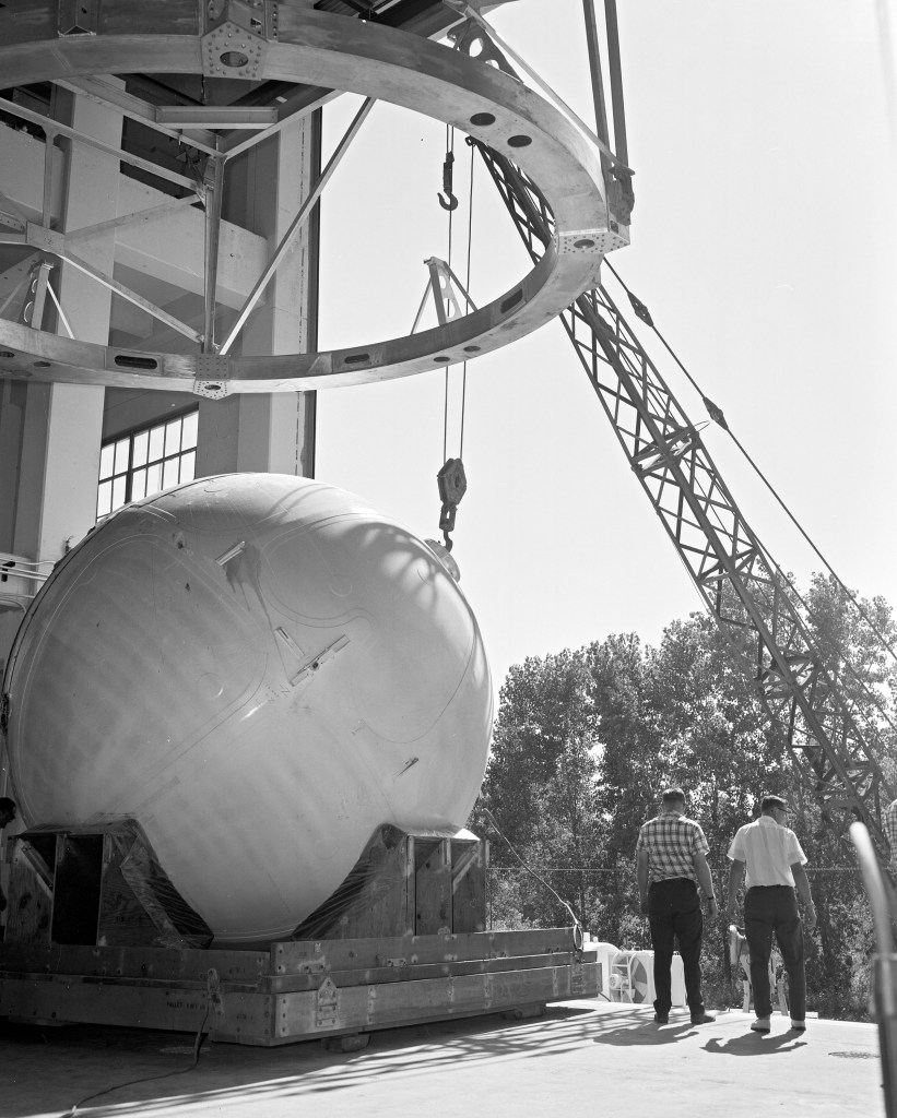 Crane lifting round tank.