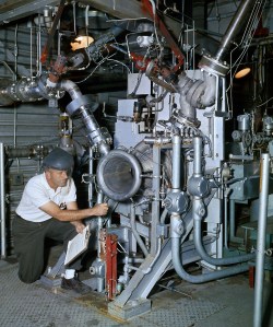 Technician working with engine inside J-1
