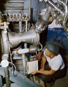 Technician working with engine inside J-1