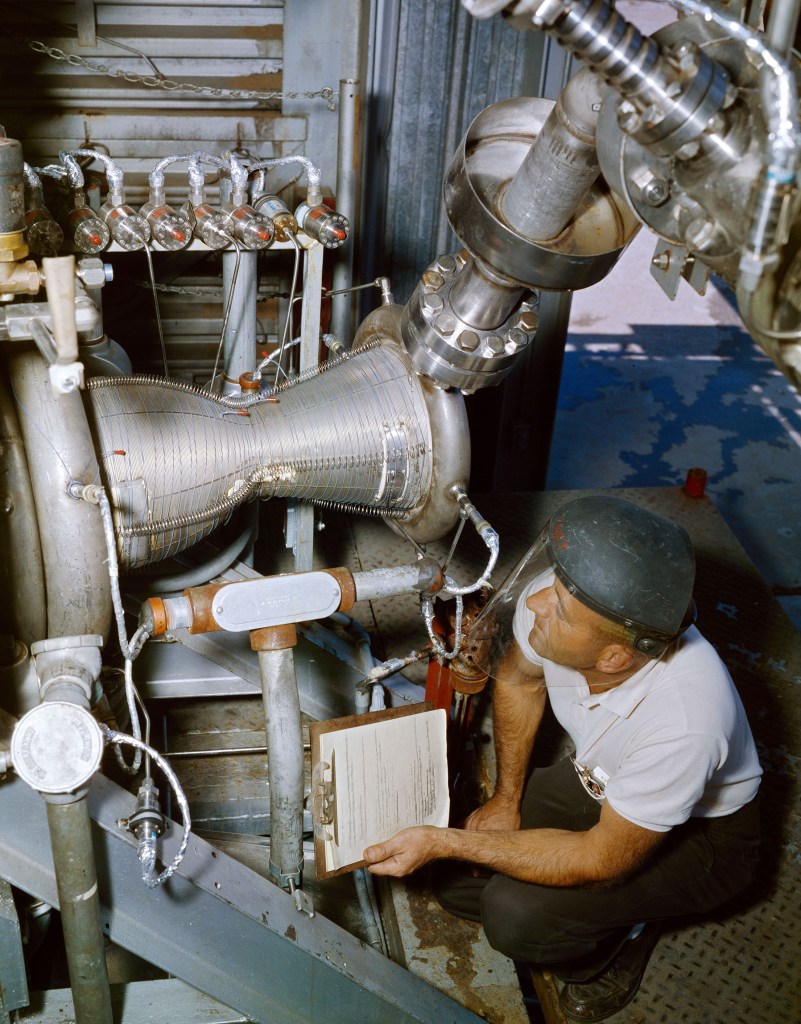 Technician working with engine inside J-1