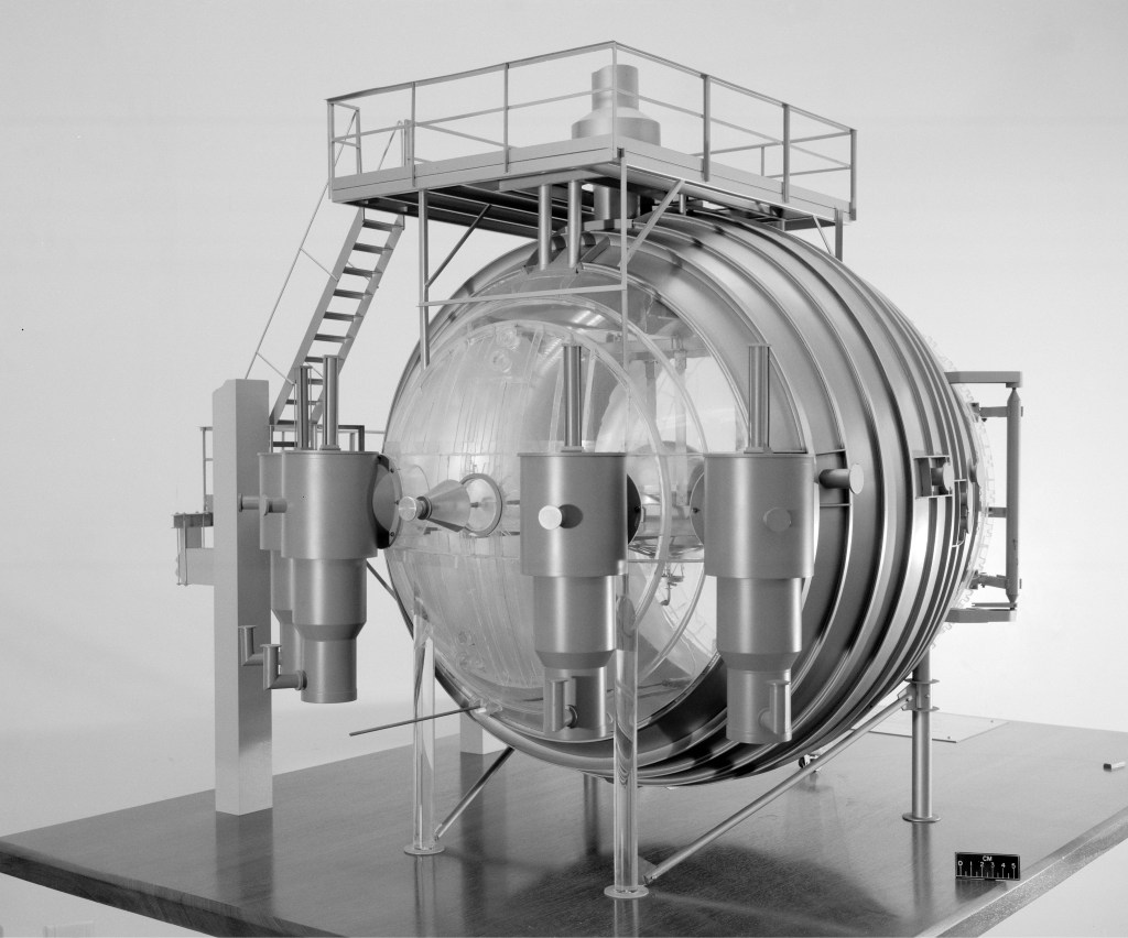 A clear plastic model of the K Site vacuum chamber.