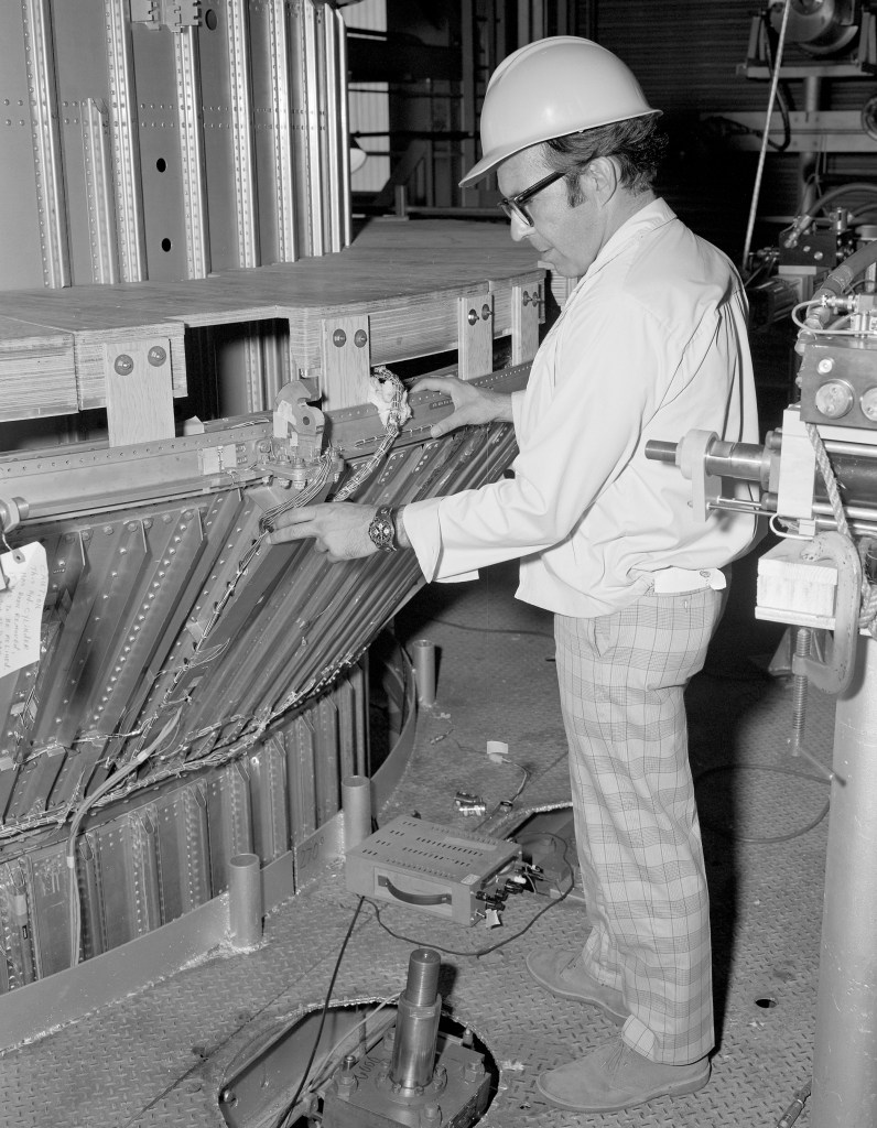 Man examining shroud hardware.