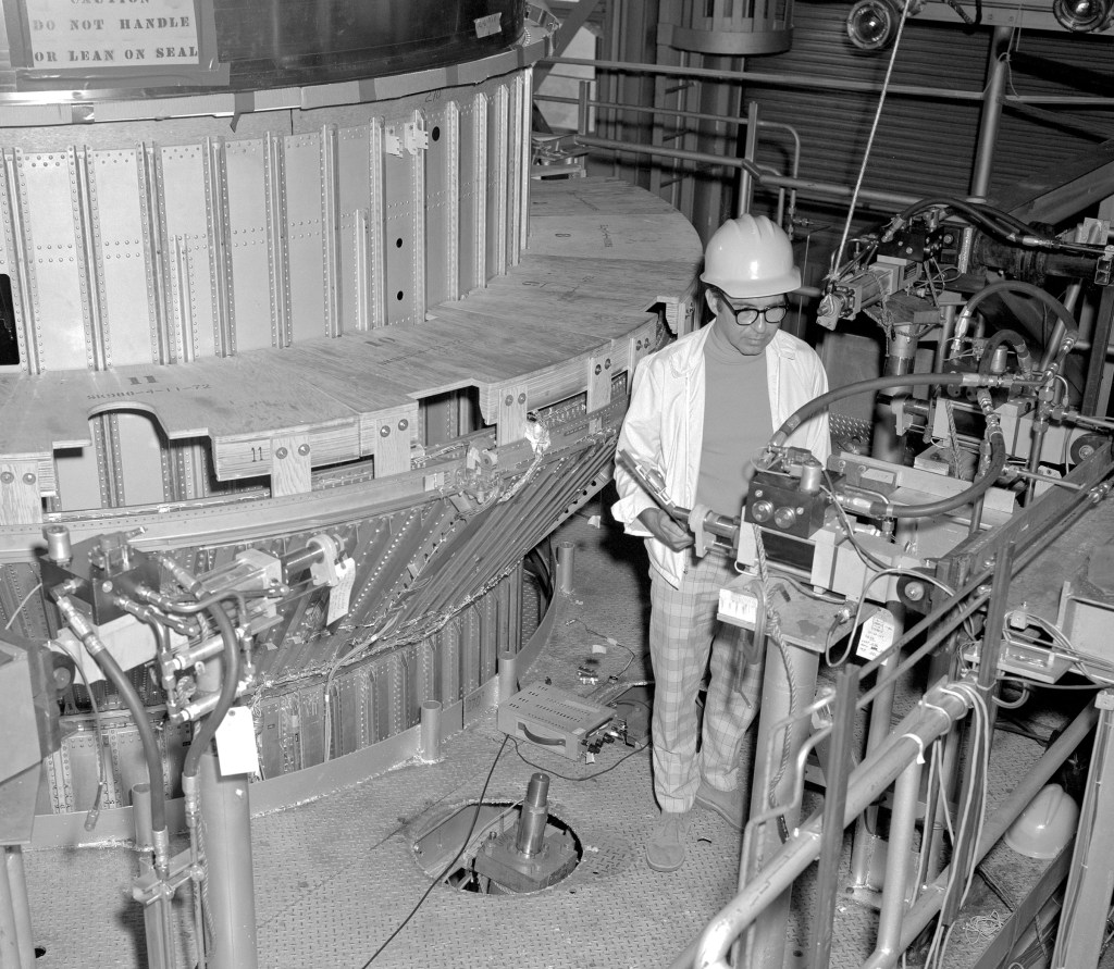 Man working on platform in test stand.