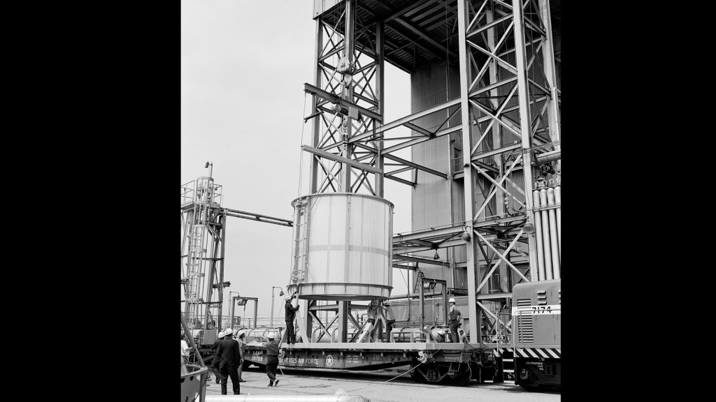 Ground-level view of crane lifting test article into B-3