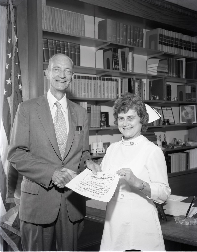 Man standing next to female nurse.