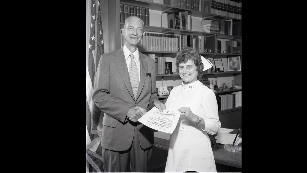 Man standing next to female nurse.