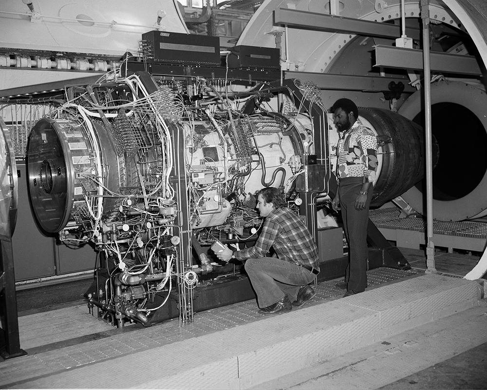 Men working on engine in test cell.