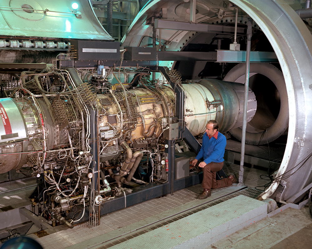 Men working on engine in test cell.