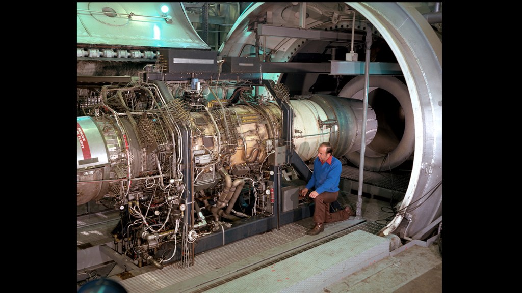 Men working on engine in test cell.