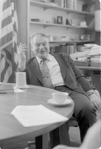 Man sitting and laughing.