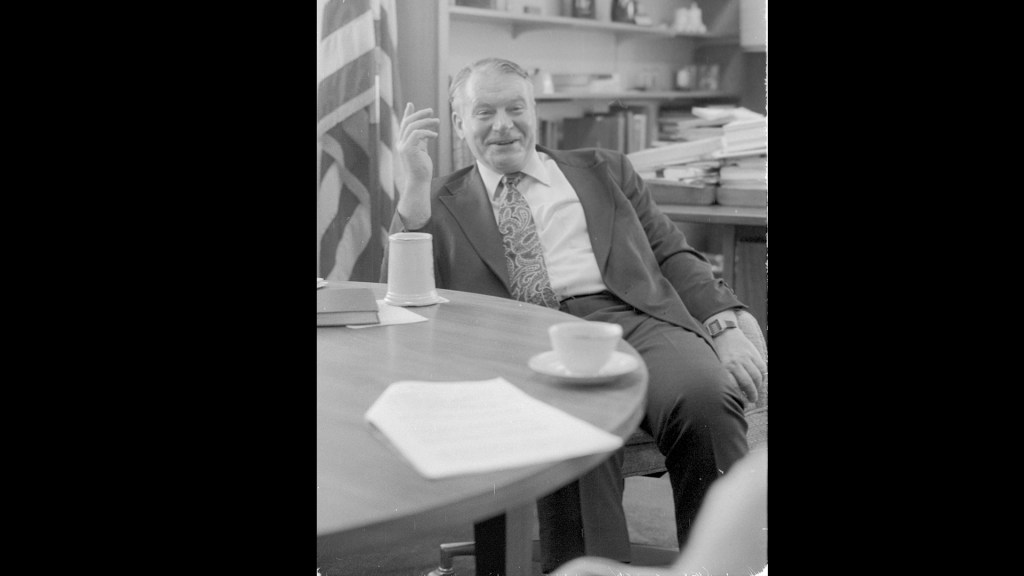 Man sitting and laughing.