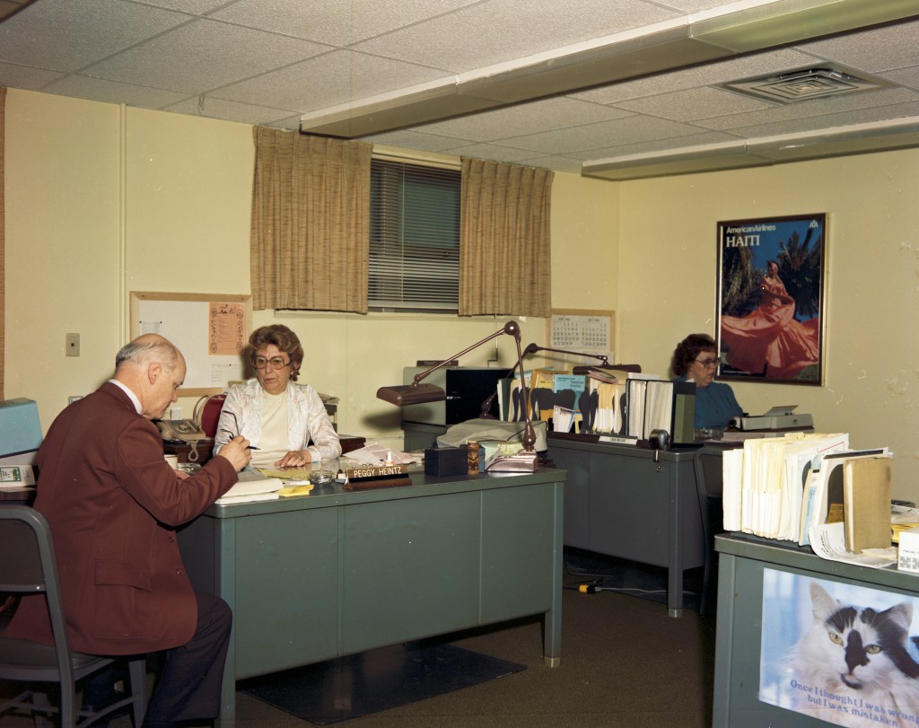 Man and woman sitting at desk.