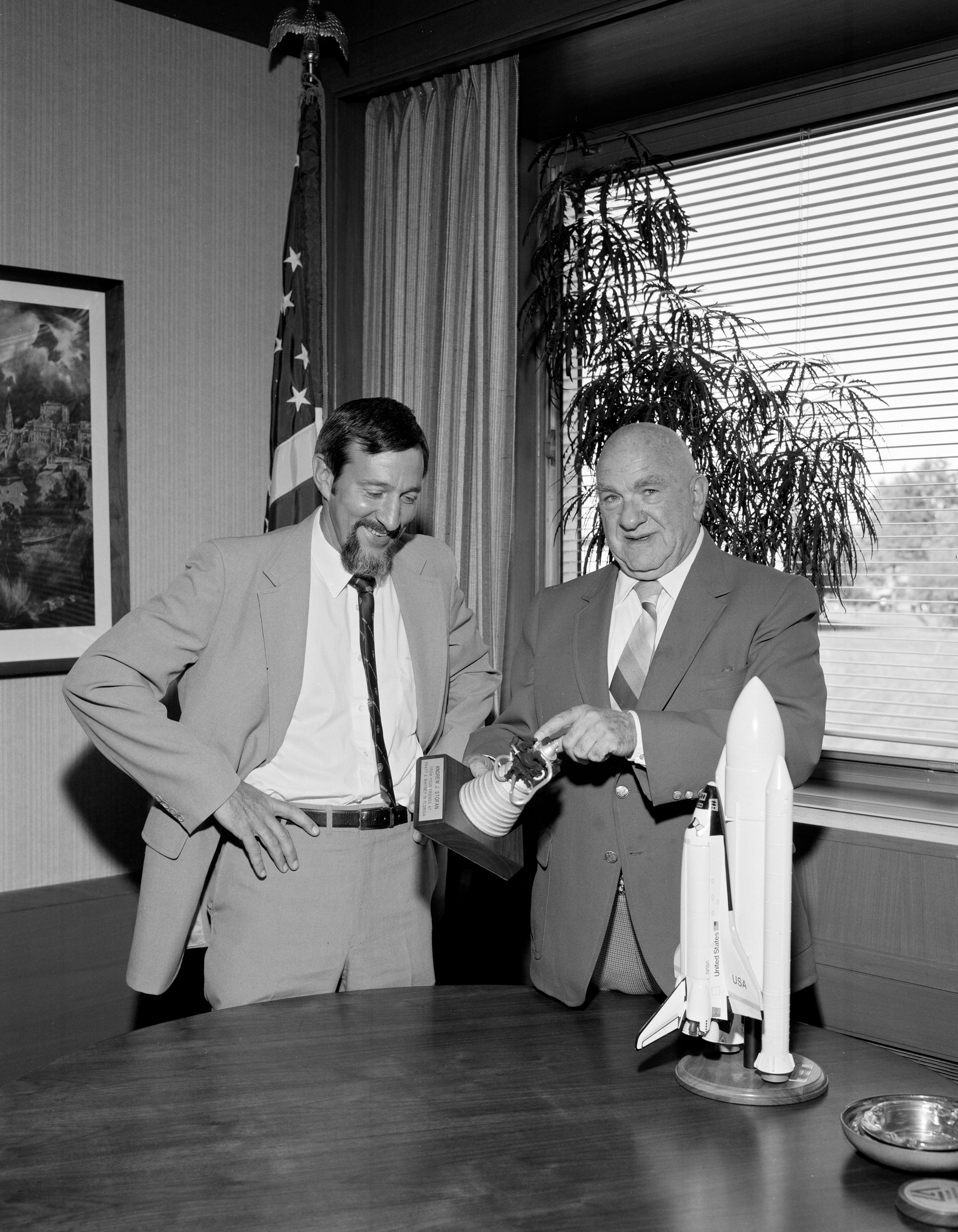 Two men looking at model.