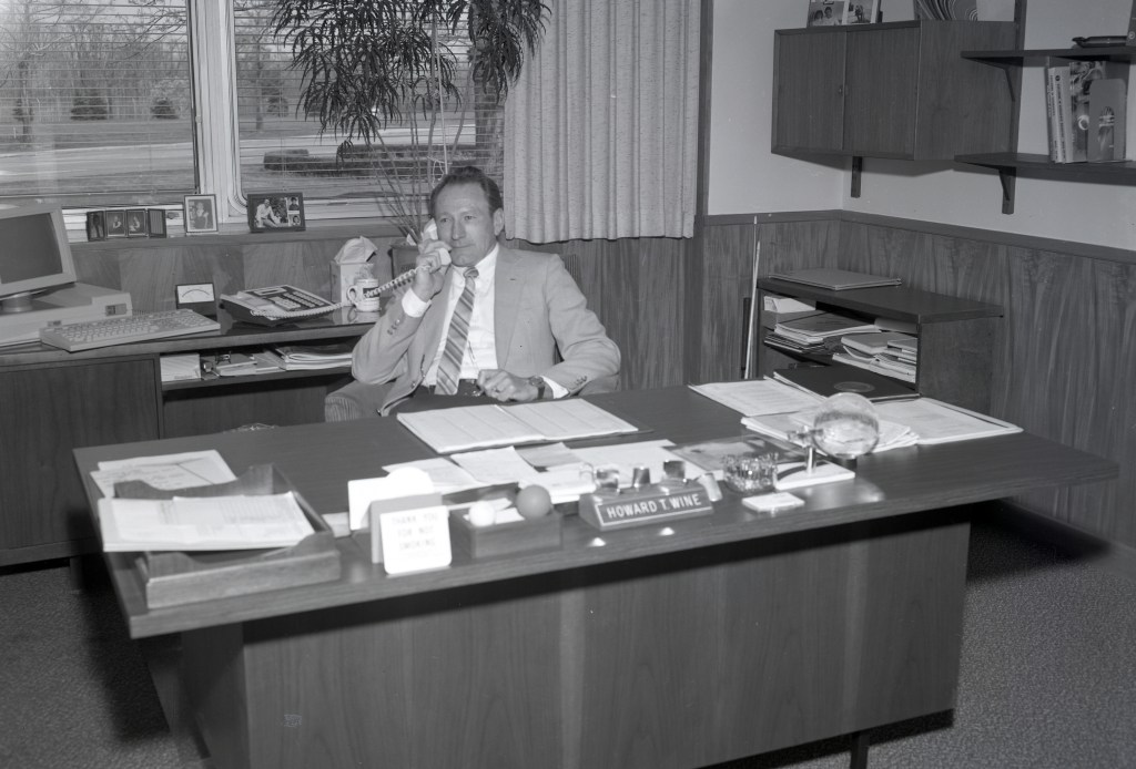 Man on phone at desk.